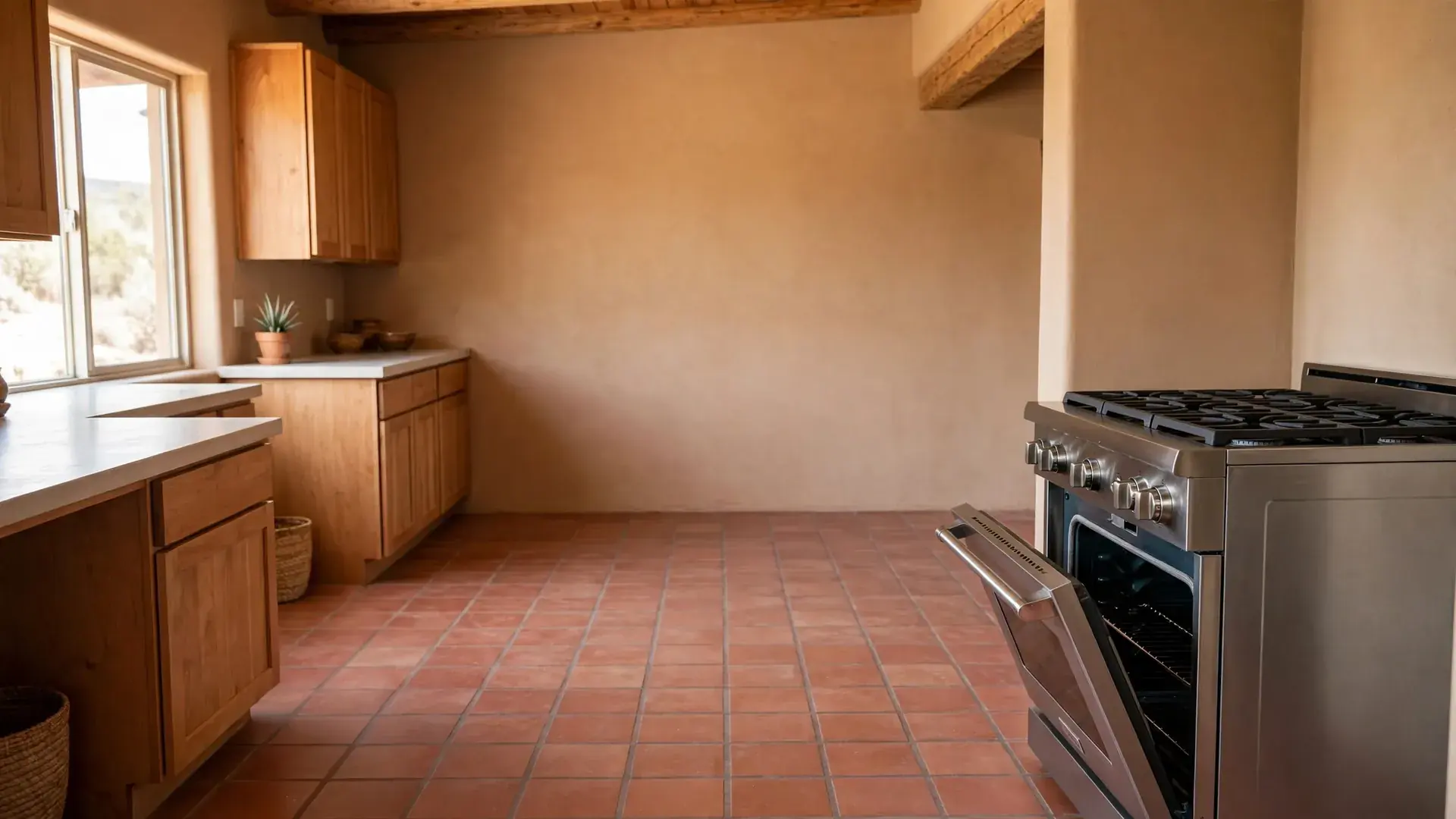 Freestanding gas range with an oven door ajar in a bright Southwestern kitchen